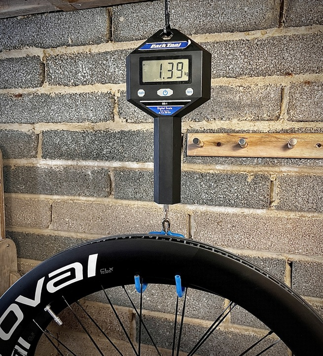 Two pairs of Roval Rapide CLX Team wheels hang from some Park Tool scales, showing the weight at 1.39kg