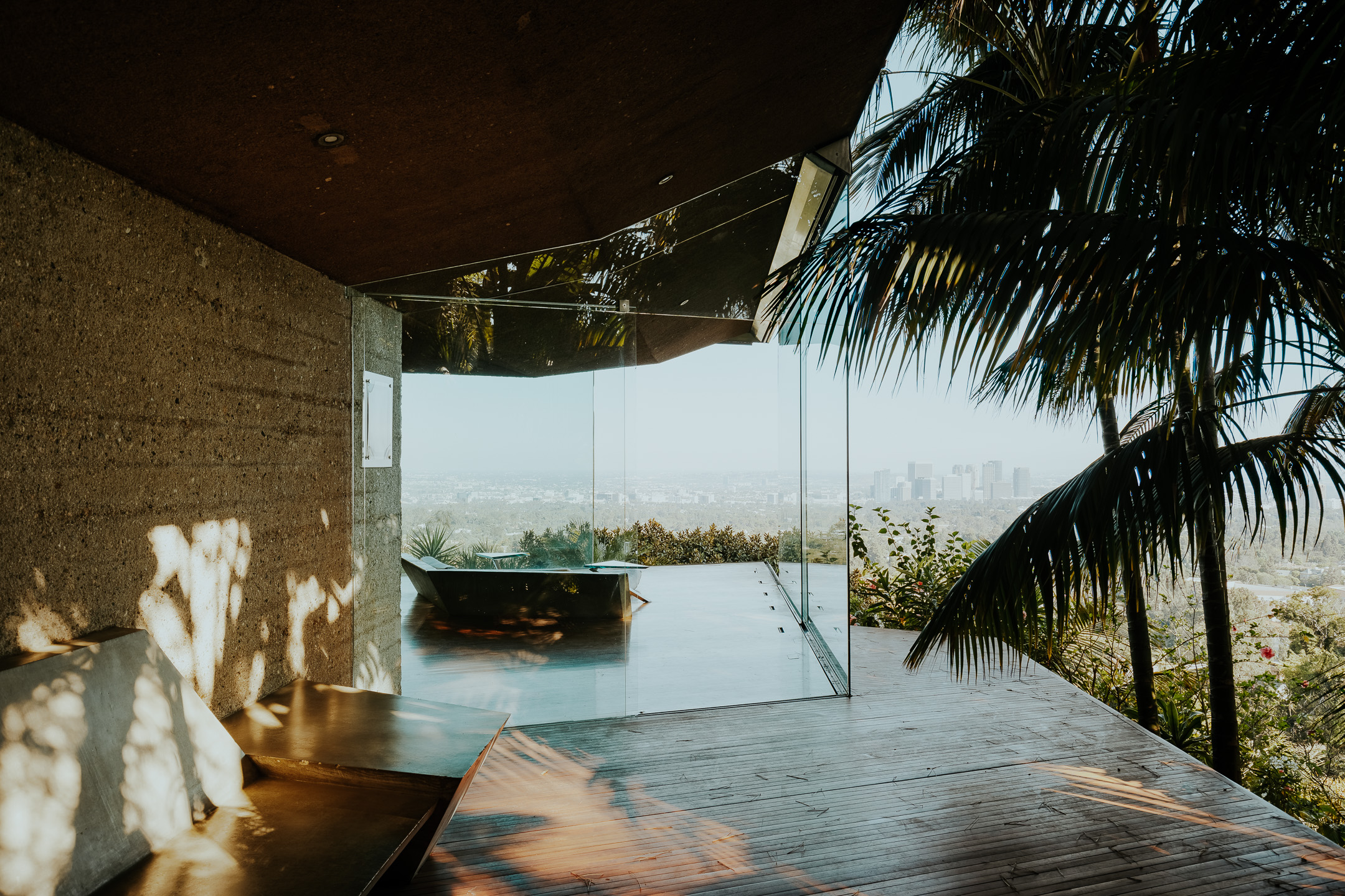 Sheats-Goldstein Residence in LA with its concrete sloped roof, pool and green open grounds