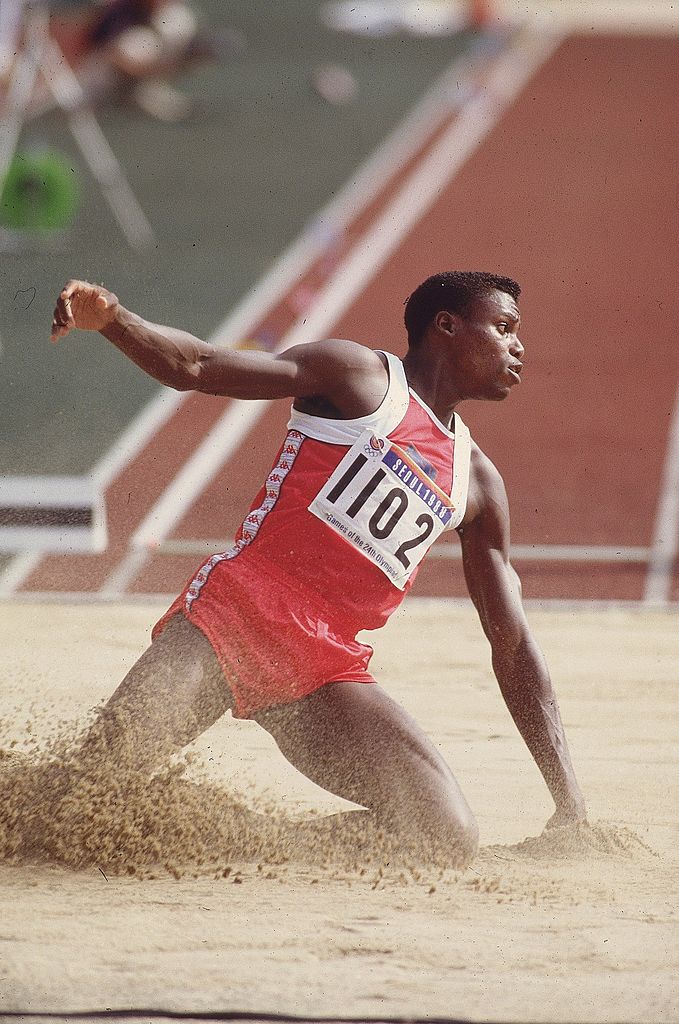 Track &amp;amp; Field 1988 Summer Olympics, USA Carl Lewis (1102) in action, landing during Long Jump at Olympic Stadium, Seoul, South Korea 9/17/1988--10/2/1988