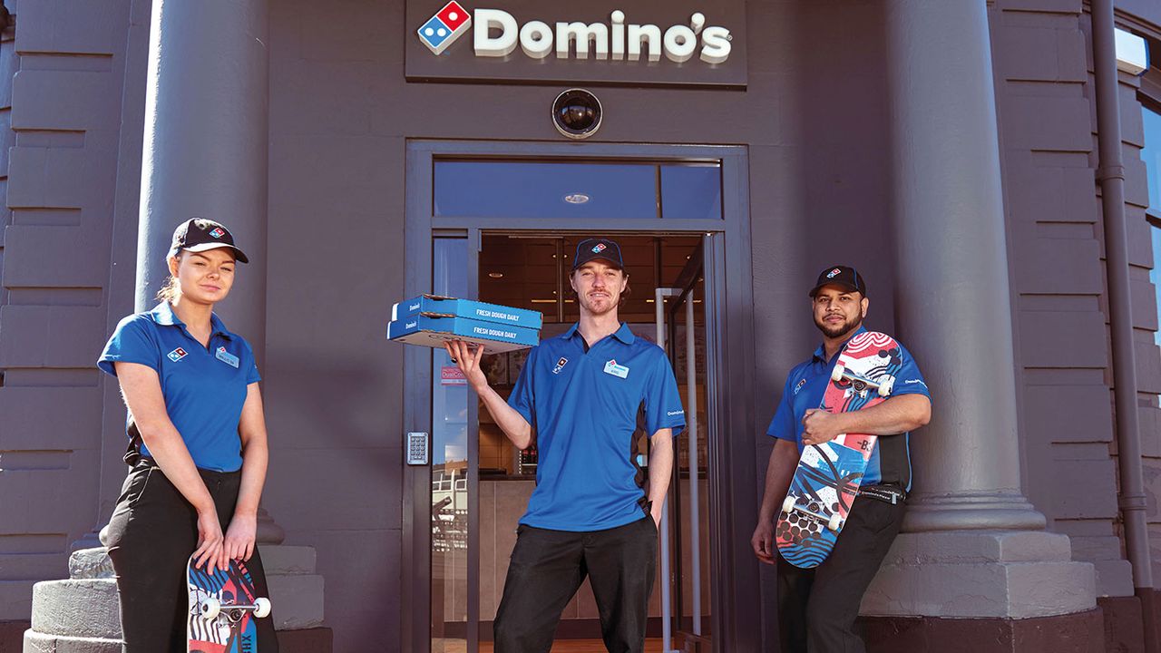 Domino&#039;s Pizza employees with skateboards 