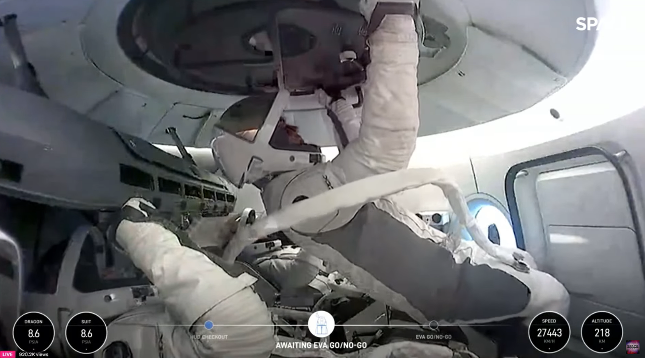 Hatch and tether are checked prior to historic spacewalk