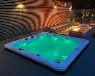 hot tub and deck lit up at night