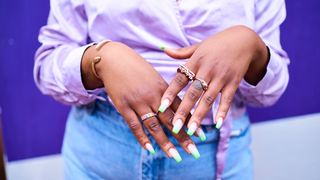 nail trends 2023 - woman with green joyful nail art