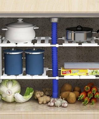 Under sink storage with pots and pans and fresh organic produce