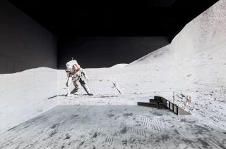 an astronaut in a white spacesuit walks on the moon.