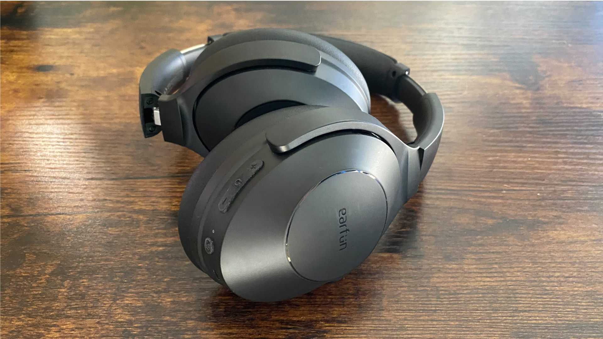 Earfun Wave Life over-ear noise-cancelling headphones on a wooden surface
