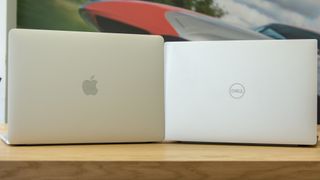 The Dell XPS 13 and Apple MacBook Pro 13in (2018) side-by-side with the lid open