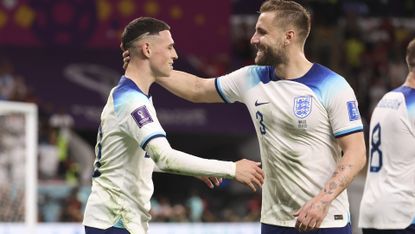 Phil Foden of England celebrates his goal with Luke Shaw during the FIFA World Cup Qatar 2022 Group B match between Wales and England at Ahmad Bin Ali Stadium on November 29, 2022 in Doha, Qatar