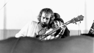 Singer Stevie Nicks and bass player John McVie of the rock group "Fleetwood Mac" perform onstage in May 1977 in Oakland, California