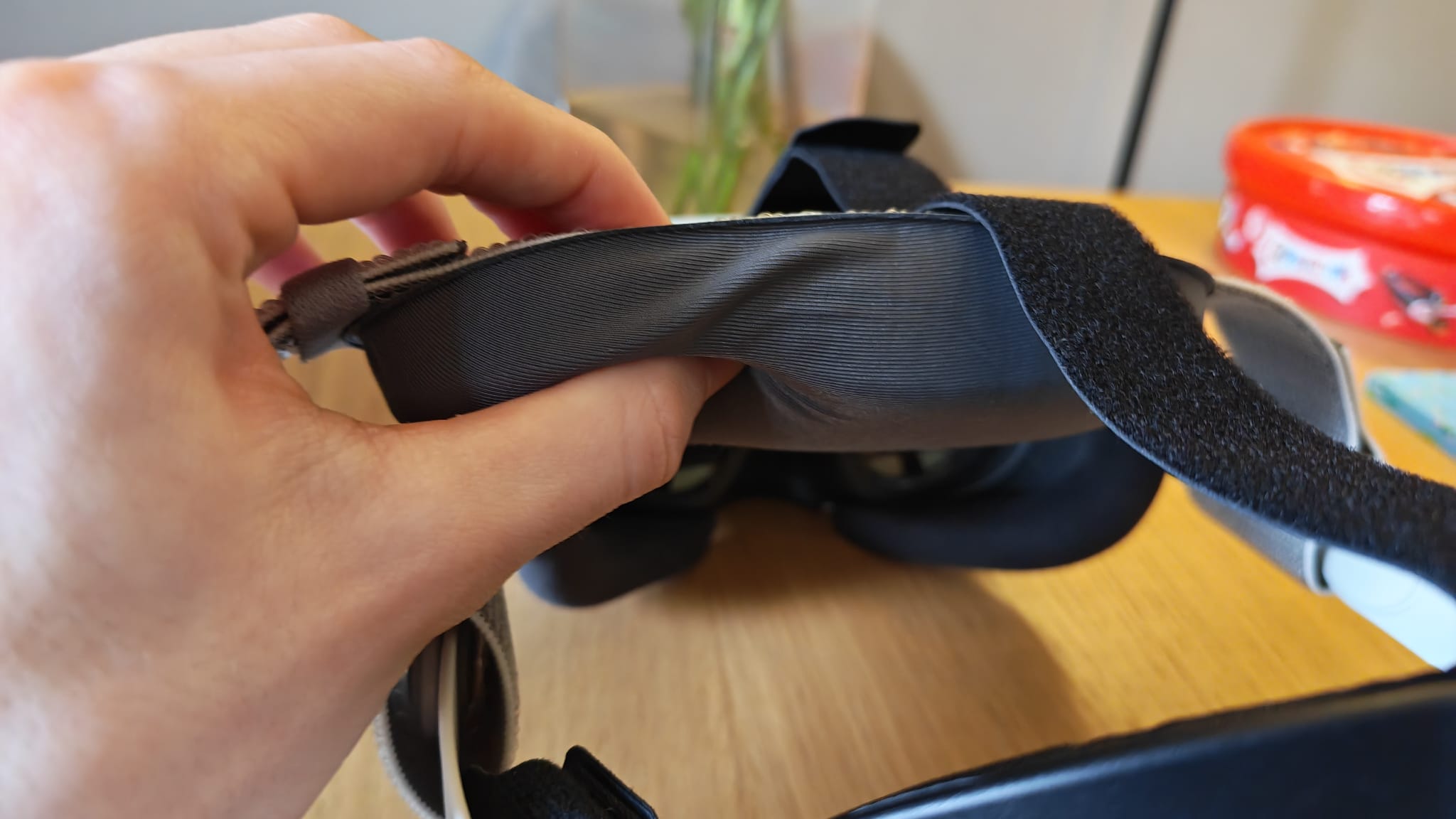 A reviewer pinching the soft cushioning on the Syntech Elite Head Strap for Quest 3