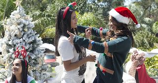 The Sharma-Rebecchi's 'Christmas in July' photoshoot for their Face of Lassiters poster in Neighbours.
