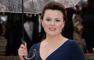 Monica Dolan, who is appearing in A Very English Scandal, shields herself under an umbrella