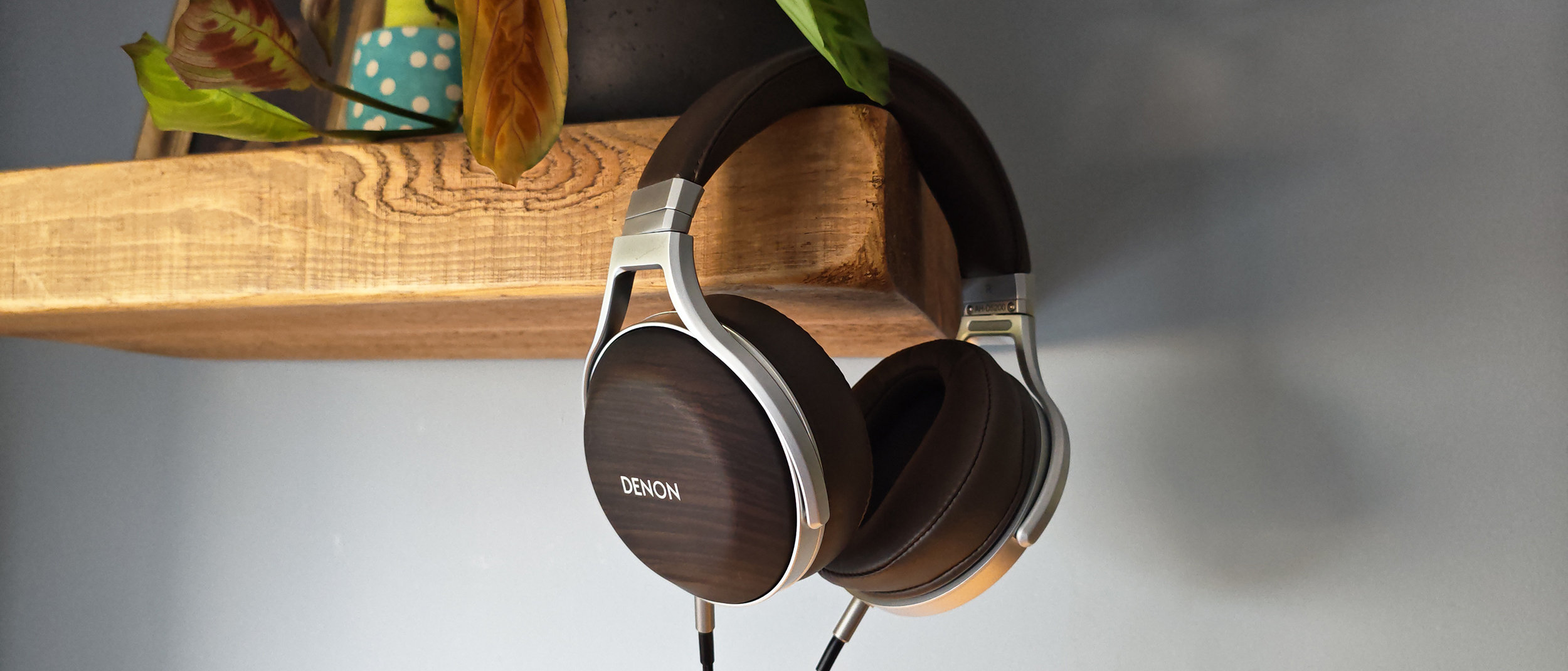 The Denon AH-D5200 and other headphones, photographed on a home desktop. 