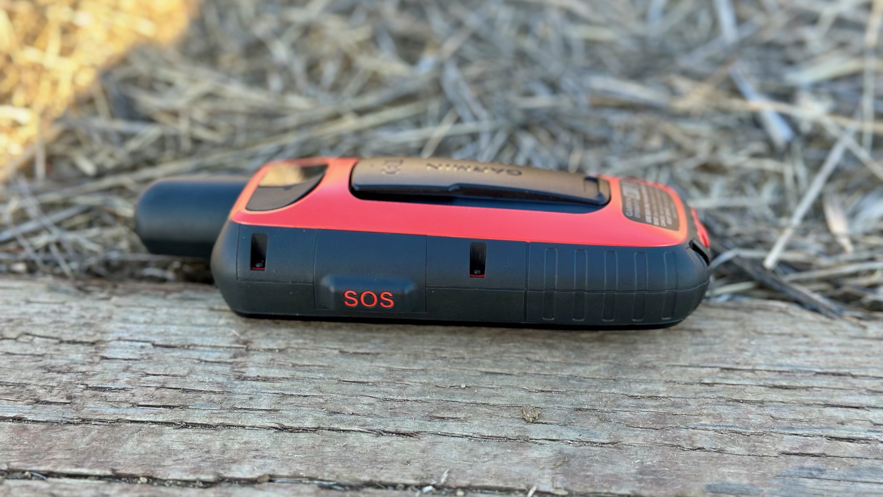 A side view of the Garmin GPSMAP 67i showing the SOS button cover