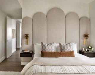 A bedroom with an upholstered wall