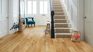 hallway floored with solid European oak rustic wood flooring and carpeted staircase