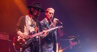 Dave Navarro and Perry Farrell perform side by side onstage in London