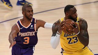 LeBron James #23 of the Los Angeles Lakers is fouled by Chris Paul #3 of the Phoenix Suns as he spins in the second quarter during game six of the Western Conference first round series at Staples Center on June 3, 2021 in Los Angeles, California.