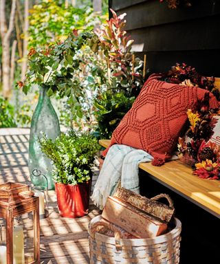 A cozy outdoor nook with outdoor cushion in fall colors