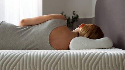 a woman sleeping on her side on a Tempur Original Pillow, to illustrate how the best pillows for side sleepers should look