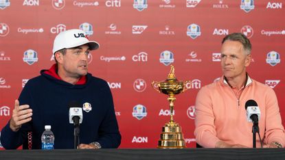 Keegan Bradley (left) and Luke Donald sit in their pre-Ryder Cup press conference with the trophy between them on the desk