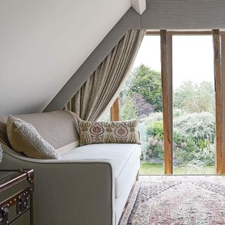 attic room with grey coloured and windows