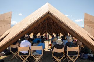 The audience listens to the musical performance in the canopy of Geode