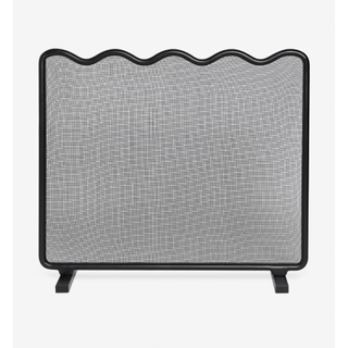 black fireplace cover with a wavy detail