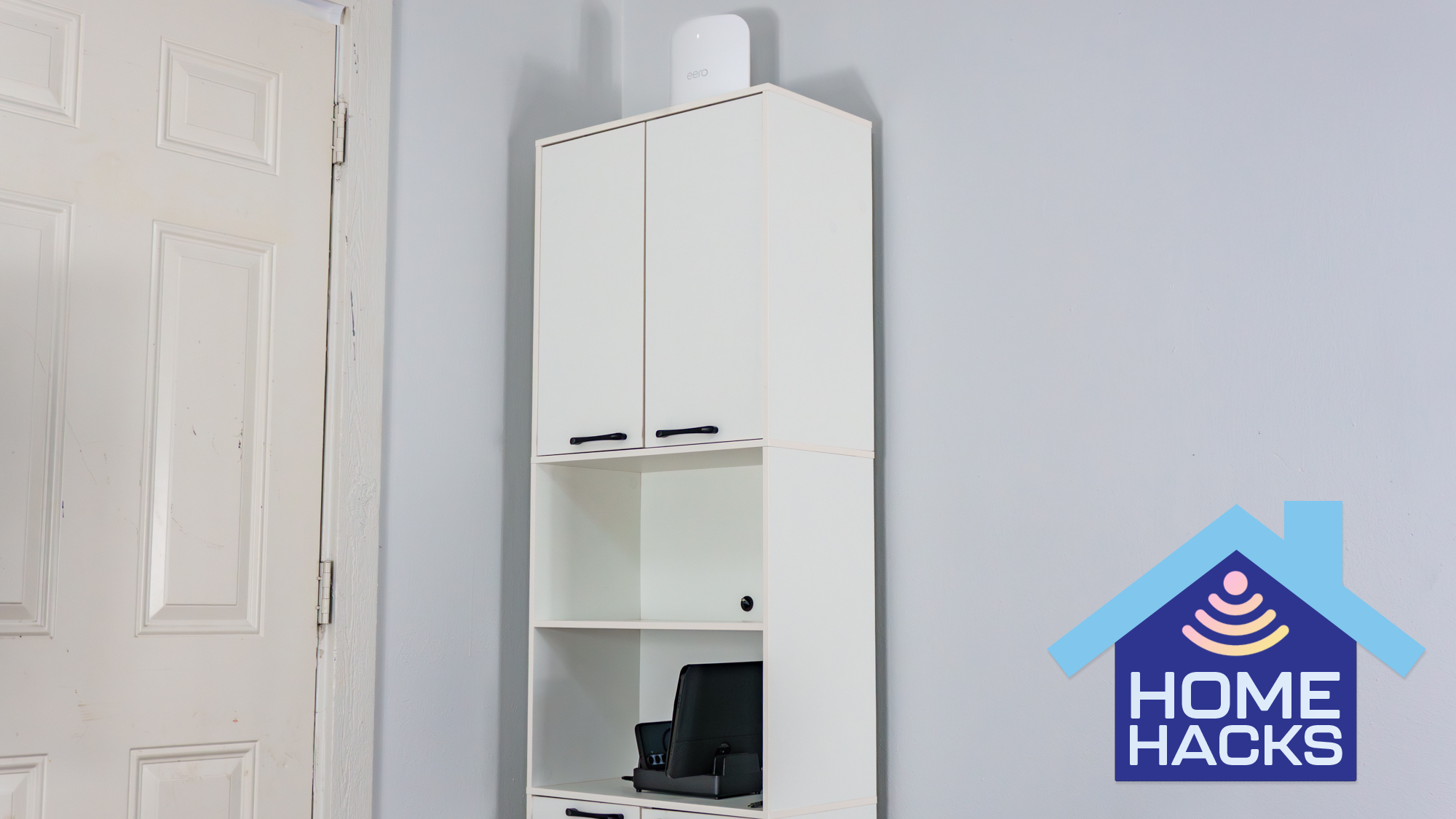 A modified kitchen pantry cabinet filled with networking gear and a mini PC with a Home Hacks badge