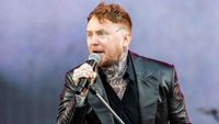 Frank Carter singing onstage with the Sex Pistols in 2025