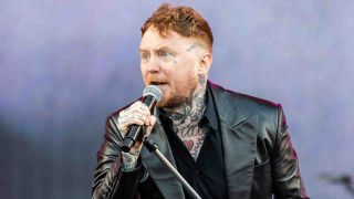 Frank Carter singing onstage with the Sex Pistols in 2025