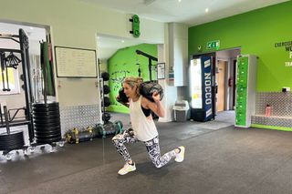 The Hyrox sandbag lunges carried out in a gym