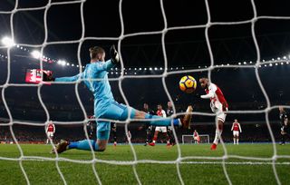 Alexandre Lacazette of Arsenal scores his teams first goal past David De Gea of Manchester United to make it 2-1 during the Premier League match between Arsenal and Manchester United at Emirates Stadium on December 2, 2017 in London, England.