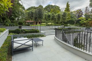 large garden ideas: paved terraces and stone steps leading up to a large lawn and garden building