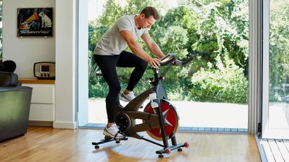 Man figuring out how to use an exercise bike