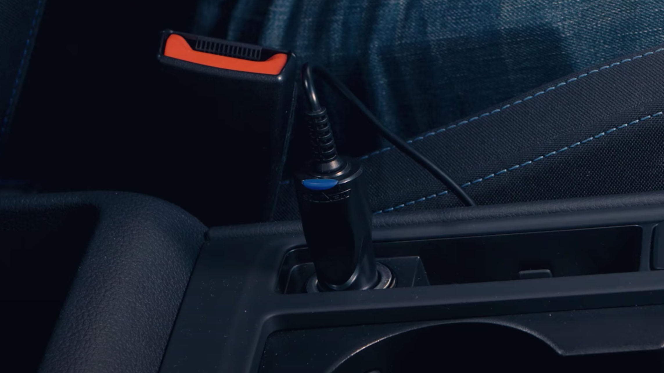 Some hands installing the a dash cam cable inside a car