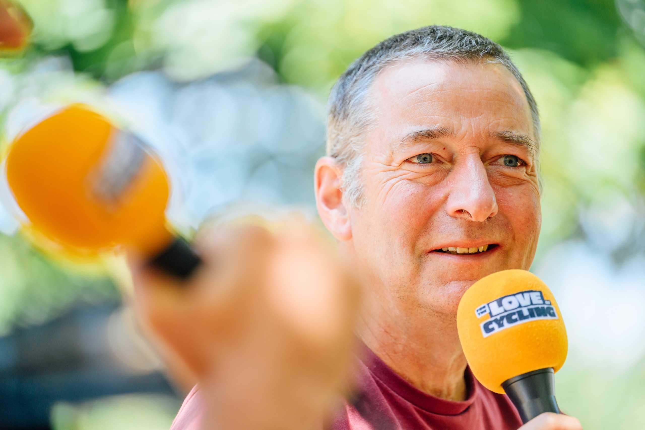 Ned Boulting in close-up with a microphone in hand