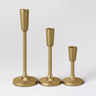 Three gold candle holders