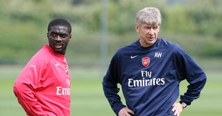 Arsenal defender Kolo Toure and manager Arsene Wenger during an Arsenal training session on May 10, 2007 in St. Albans, England.