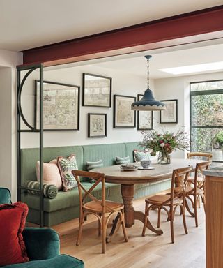 dining area with round wooden table and wooden chairs and a green dining bench