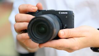 Two hands holding the Canon EOS M6 Mark II