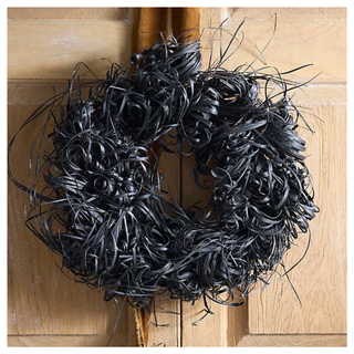 A dried black tiririca wreath from Anthropologie