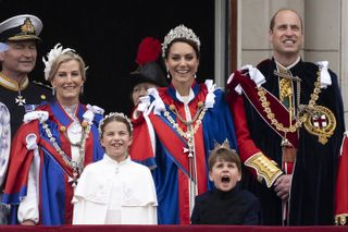 Duchess Sophie, Princess Charlotte, Kate Middleton, Prince Louis and Prince William wearing coronation robes standing on the balcony of Buckingham Palace