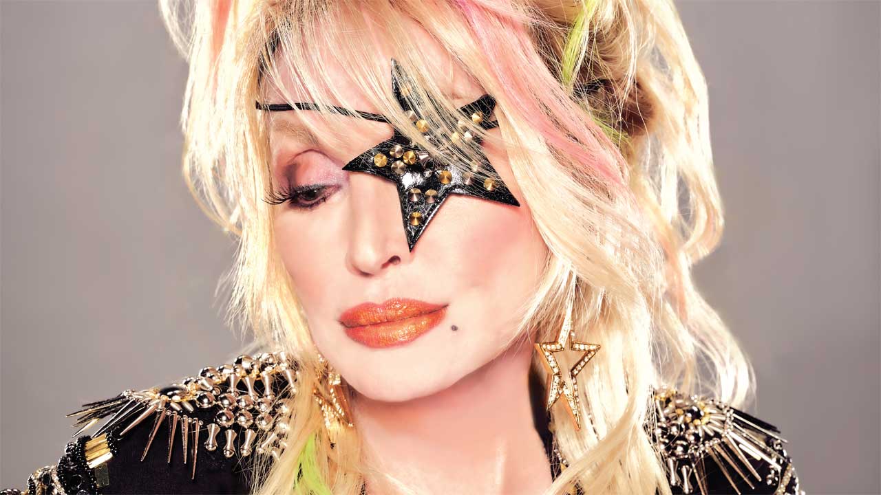Dolly Parton headshot with a rhinestone patch over one eye