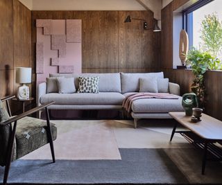 mid-century style furniture in a room with wooden wall panels and muted colours