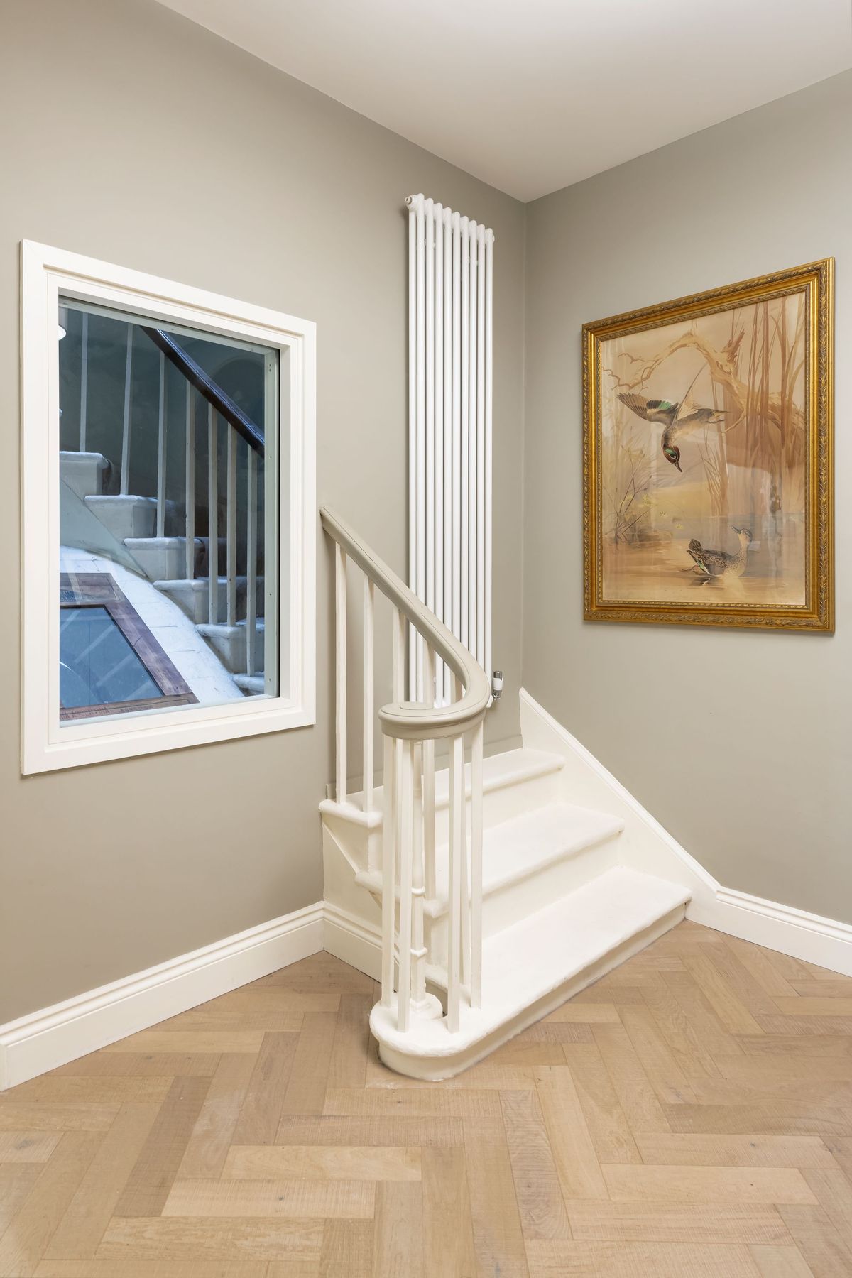 A stairwell leading to nowhere with a radiator on the wall