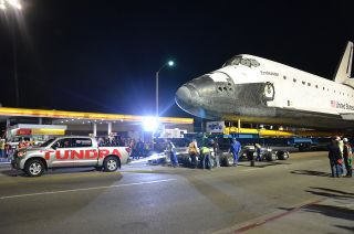 Space shuttle Endeavour is seen being towed by a 2012 Toyota Tundra truck in Los Angeles, Oct. 12, 2012. 