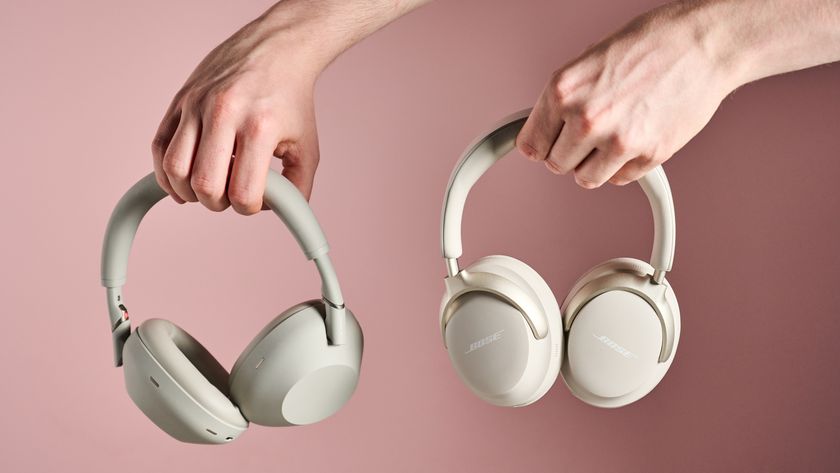 Person holding Sony WH-1000XM6 and Bose QuietComfort Ultra
