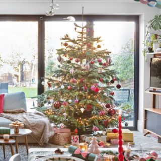 Christmas tree with red decorations in living dining area