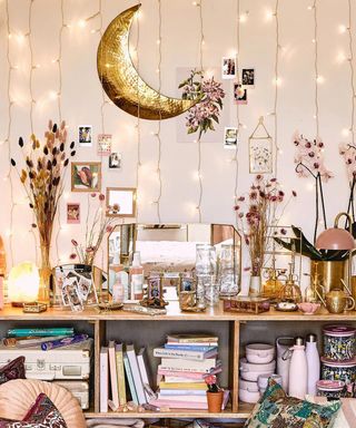 fairy light curtain behind a bookshelf by urban outfitters
